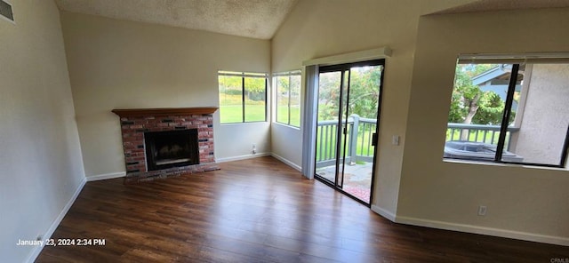 3040 Charwood Ct, Spring Valley, CA 91977 - unfurnished living room with wood finished floors, a brick fireplace, high vaulted ceiling, and a textured ceiling
