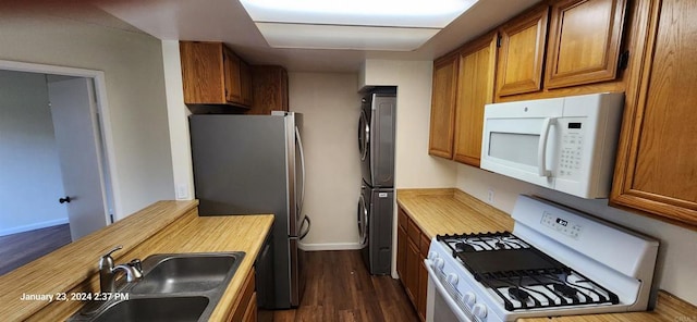 3040 Charwood Ct, Spring Valley, CA 91977 - kitchen with white appliances, stacked washing machine and dryer, brown cabinetry, dark wood finished floors, and butcher block counters