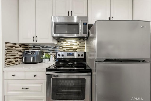 7742 Redlands St Unit H1027, Playa Del Rey, CA 90293 - kitchen with stainless steel appliances, white cabinetry, and backsplash