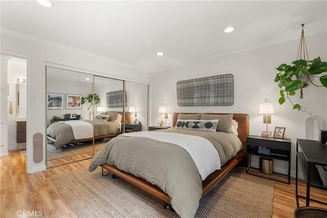 7742 Redlands St Unit H1027, Playa Del Rey, CA 90293 - bedroom featuring light wood-type flooring, ornamental molding, recessed lighting, a closet, and connected bathroom