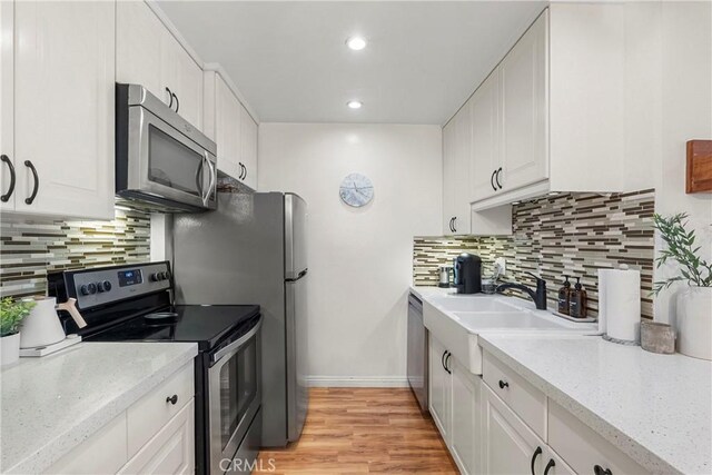 7742 Redlands St Unit H1027, Playa Del Rey, CA 90293 - kitchen featuring stainless steel appliances, tasteful backsplash, white cabinetry, light wood-style flooring, and recessed lighting