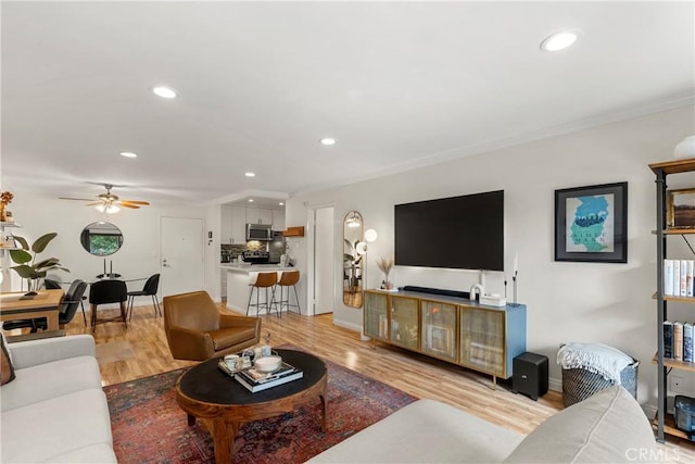 7742 Redlands St Unit H1027, Playa Del Rey, CA 90293 - living area featuring recessed lighting, light wood-style flooring, a ceiling fan, and crown molding