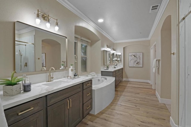 3017 Rue Montreux, Escondido, CA 92026 - full bathroom featuring wood finished floors, a shower stall, crown molding, two vanities, and a garden tub