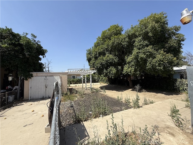 615 E 12th St, Pomona, CA 91766 - view of yard featuring a storage unit and a patio