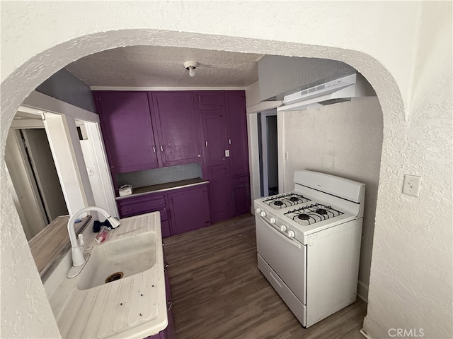 615 E 12th St, Pomona, CA 91766 - kitchen featuring gas range gas stove, a textured wall, under cabinet range hood, arched walkways, and wood finished floors