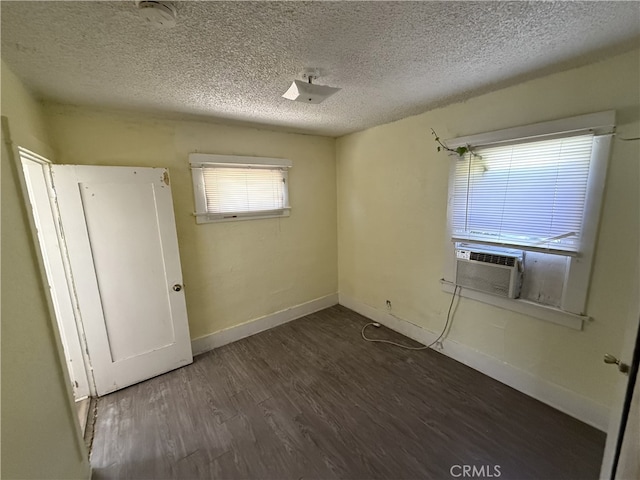 615 E 12th St, Pomona, CA 91766 - unfurnished bedroom featuring dark wood-type flooring, cooling unit, and a textured ceiling