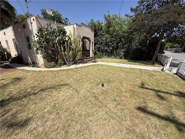 615 E 12th St, Pomona, CA 91766 - view of front of home featuring a front lawn and stucco siding
