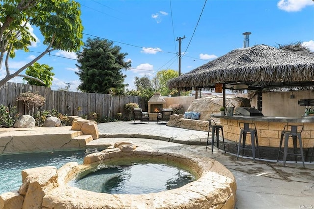 24252 Palmek Cir, Lake Forest, CA 92630 - view of pool featuring a warm lit fireplace, a fenced backyard, a patio area, and a pool with connected hot tub