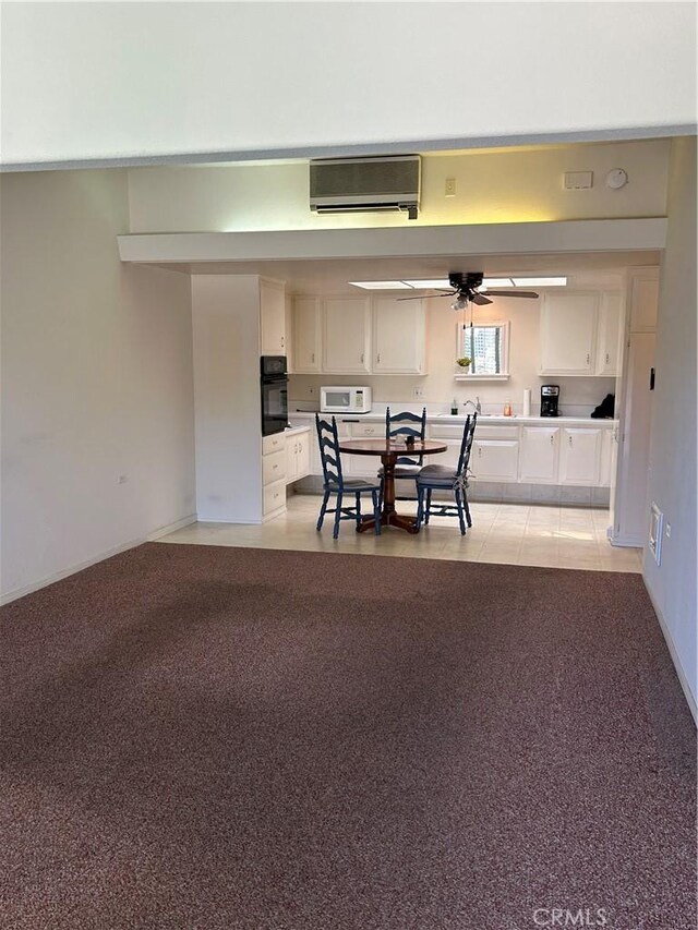 13361 N Fairfield Unit 180J, Seal Beach, CA 90740 - dining area with an AC wall unit and ceiling fan