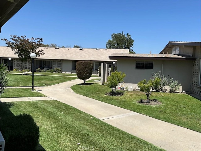 13361 N Fairfield Unit 180J, Seal Beach, CA 90740 - view of front of house with stucco siding and a front lawn
