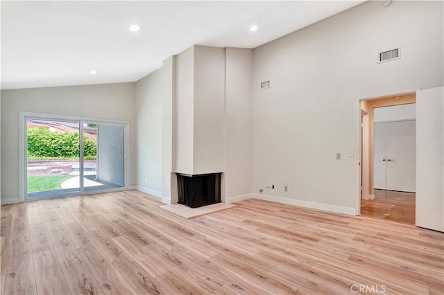 23415 Park Hacienda, Calabasas, CA 91302 - unfurnished living room with high vaulted ceiling, light wood-type flooring, a multi sided fireplace, and recessed lighting