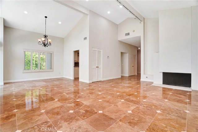 23415 Park Hacienda, Calabasas, CA 91302 - unfurnished living room with high vaulted ceiling, rail lighting, a chandelier, and a fireplace