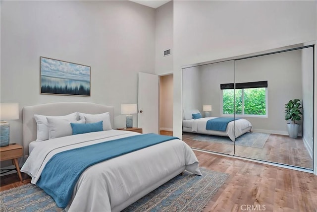 23415 Park Hacienda, Calabasas, CA 91302 - bedroom featuring wood finished floors, a closet, and a towering ceiling