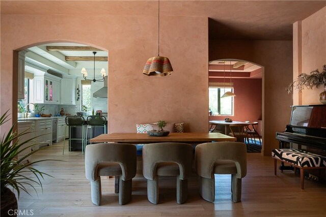 4620 Morse Ave, Sherman Oaks, CA 91423 - dining area with arched walkways, light wood finished floors, and plenty of natural light