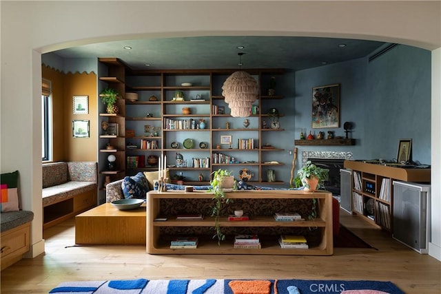 4620 Morse Ave, Sherman Oaks, CA 91423 - living area featuring arched walkways, light wood-style floors, and a fireplace