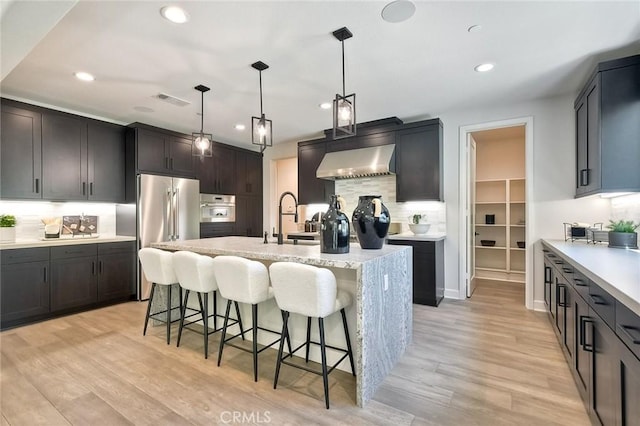 3042 Mesa Gln, Escondido, CA 92026 - kitchen featuring extractor fan, stainless steel appliances, tasteful backsplash, recessed lighting, and a kitchen bar