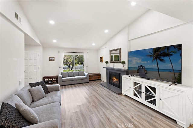 22391 Lombardi, Laguna Hills, CA 92653 - living area with a glass covered fireplace, recessed lighting, light wood-style floors, and high vaulted ceiling
