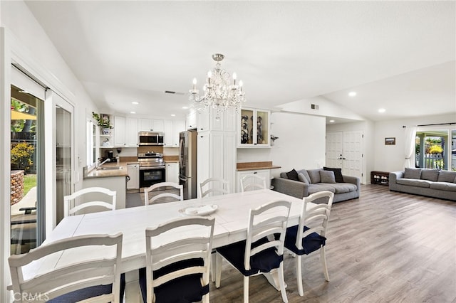22391 Lombardi, Laguna Hills, CA 92653 - dining space featuring a chandelier, light wood-type flooring, recessed lighting, and vaulted ceiling