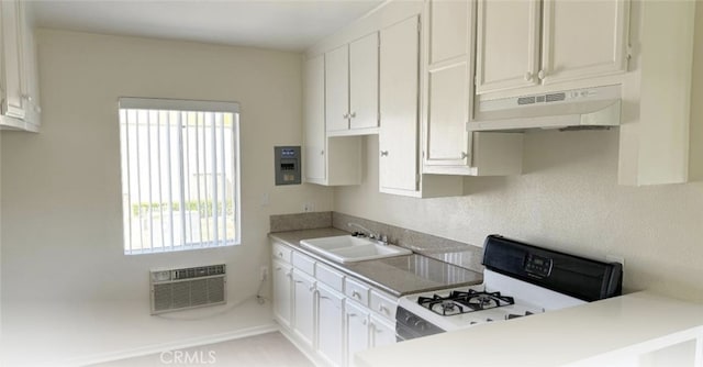 625-627 S Wabash Ave, Glendora, CA 91740 - kitchen with under cabinet range hood, white range with gas stovetop, white cabinetry, and a wall mounted AC