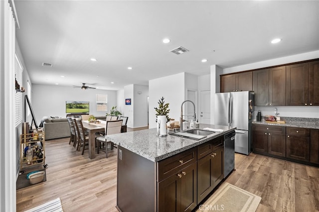 5609 Garibaldi Way, Fontana, CA 92336 - kitchen featuring appliances with stainless steel finishes, light wood-type flooring, dark brown cabinetry, open floor plan, and recessed lighting