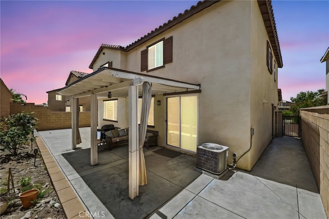 5609 Garibaldi Way, Fontana, CA 92336 - rear view of property featuring stucco siding, a patio, a fenced backyard, a gate, and a tiled roof
