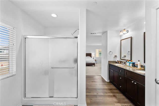 5609 Garibaldi Way, Fontana, CA 92336 - ensuite bathroom featuring double vanity, a shower stall, wood finished floors, and recessed lighting