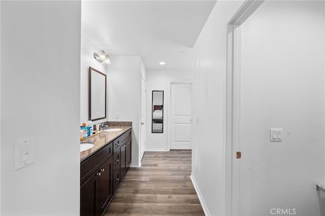 5609 Garibaldi Way, Fontana, CA 92336 - bathroom with double vanity, wood finished floors, and recessed lighting