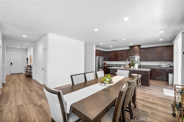 5609 Garibaldi Way, Fontana, CA 92336 - dining room with recessed lighting and light wood finished floors