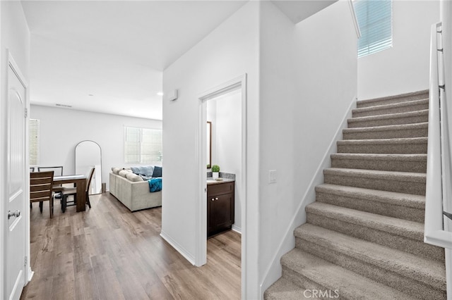 5609 Garibaldi Way, Fontana, CA 92336 - stairway featuring wood finished floors