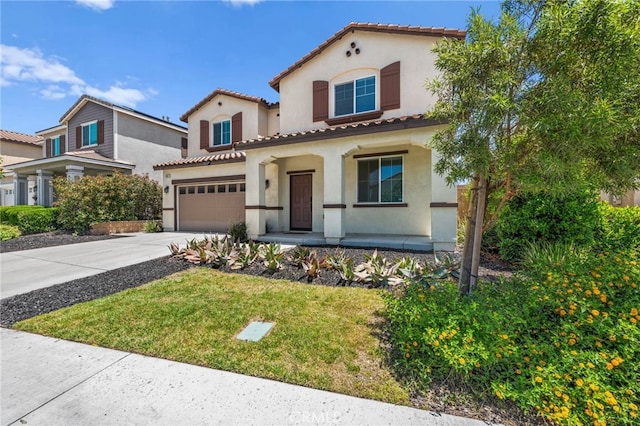 5609 Garibaldi Way, Fontana, CA 92336 - mediterranean / spanish-style home featuring covered porch, stucco siding, concrete driveway, a tiled roof, and a front lawn