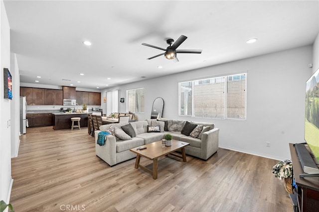 5609 Garibaldi Way, Fontana, CA 92336 - living room with recessed lighting, light wood-style flooring, plenty of natural light, and a ceiling fan