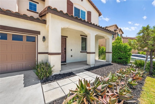 5609 Garibaldi Way, Fontana, CA 92336 - view of front of home with a porch, stucco siding, and a tile roof