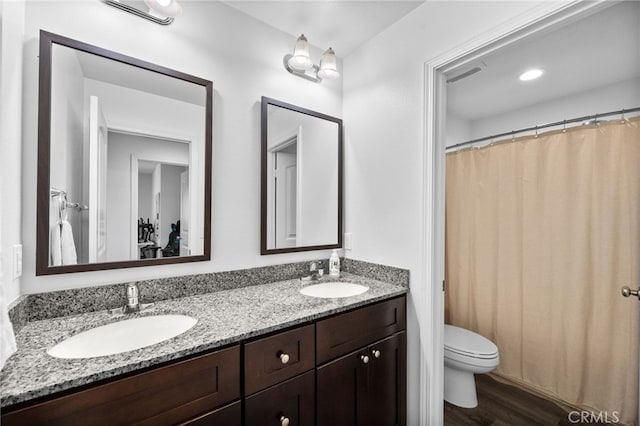 5609 Garibaldi Way, Fontana, CA 92336 - bathroom featuring double vanity, wood finished floors, and curtained shower