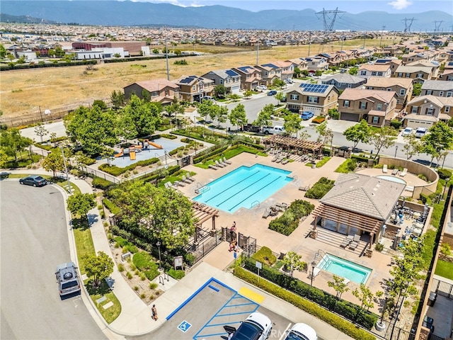 5609 Garibaldi Way, Fontana, CA 92336 - aerial perspective of suburban area with a pool area and mountains