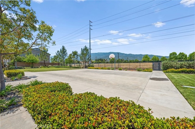 5609 Garibaldi Way, Fontana, CA 92336 - view of patio / terrace featuring community basketball court, a mountain view, and a gate