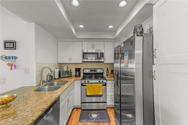 6210 Hartford Rd Unit 201, Yorba Linda, CA 92887 - kitchen featuring appliances with stainless steel finishes, recessed lighting, light stone counters, white cabinetry, and tasteful backsplash