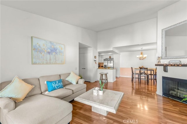 6210 Hartford Rd Unit 201, Yorba Linda, CA 92887 - living room featuring light wood finished floors and a chandelier