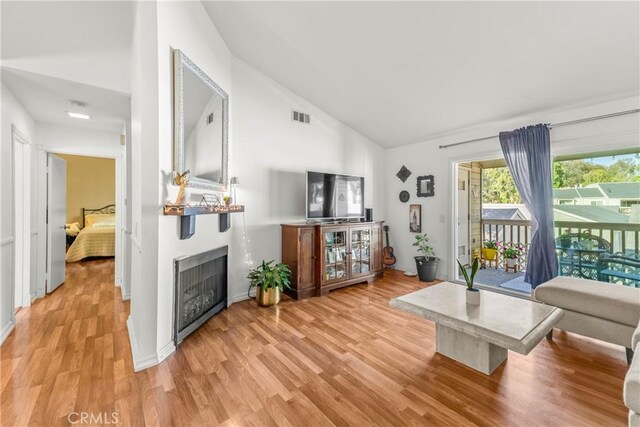 6210 Hartford Rd Unit 201, Yorba Linda, CA 92887 - living room featuring light wood-type flooring, a fireplace, and high vaulted ceiling