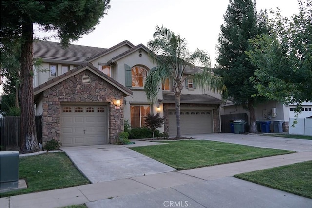 3569 Sepulveda Ave, Merced, CA 95348 - view of front of home with concrete driveway, stucco siding, stone siding, and a tiled roof