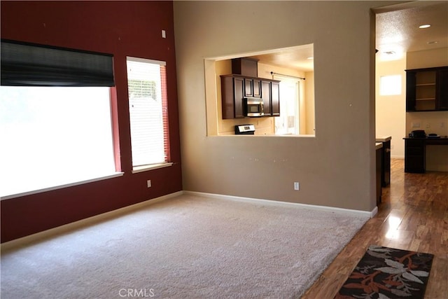 3569 Sepulveda Ave, Merced, CA 95348 - unfurnished living room with baseboards and wood finished floors