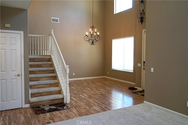 3569 Sepulveda Ave, Merced, CA 95348 - staircase with a high ceiling, healthy amount of natural light, a chandelier, and wood finished floors