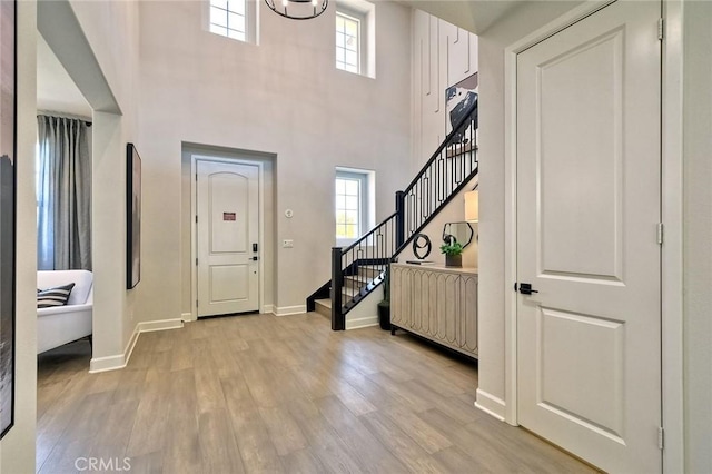 3091 Orchard Gln, Escondido, CA 92026 - entryway featuring stairs, plenty of natural light, light wood-type flooring, and a high ceiling