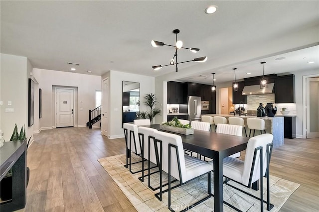 3091 Orchard Gln, Escondido, CA 92026 - dining space featuring light wood-type flooring, a chandelier, recessed lighting, and stairway
