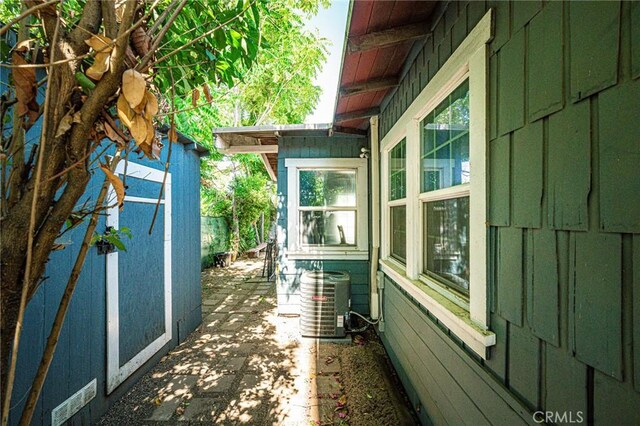 220 Palm Pl, Pomona, CA 91767 - view of side of home featuring board and batten siding and a patio area