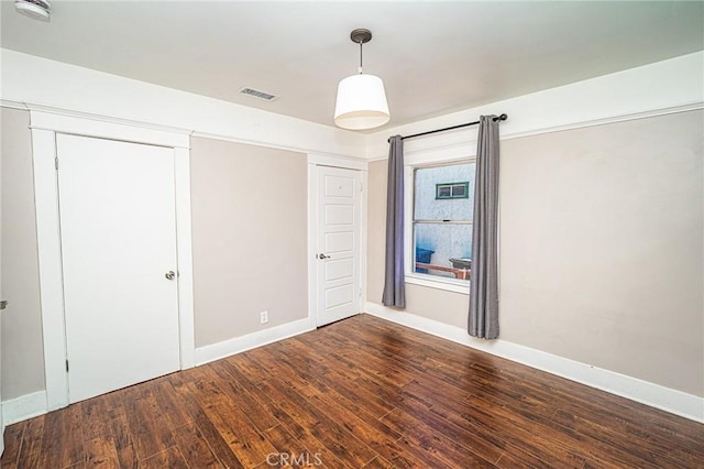 220 Palm Pl, Pomona, CA 91767 - unfurnished bedroom featuring wood finished floors and baseboards