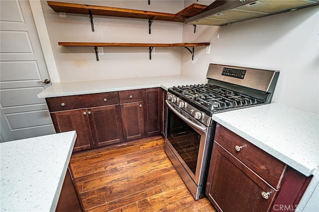220 Palm Pl, Pomona, CA 91767 - kitchen with gas range, wall chimney exhaust hood, open shelves, and wood finished floors