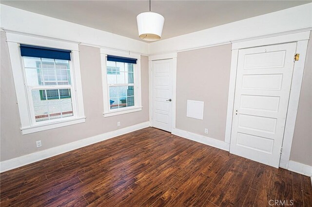 220 Palm Pl, Pomona, CA 91767 - unfurnished bedroom with dark wood-type flooring and a closet