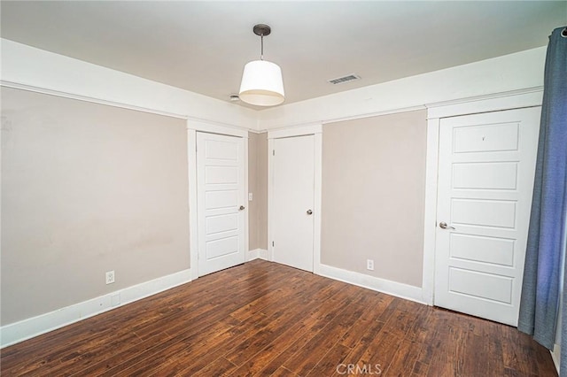 220 Palm Pl, Pomona, CA 91767 - unfurnished bedroom with wood finished floors and baseboards