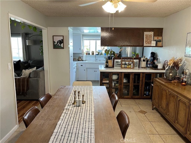 208 Spruce St, Arroyo Grande, CA 93420 - kitchen with ceiling fan, a textured ceiling, light tile patterned floors, and tile countertops