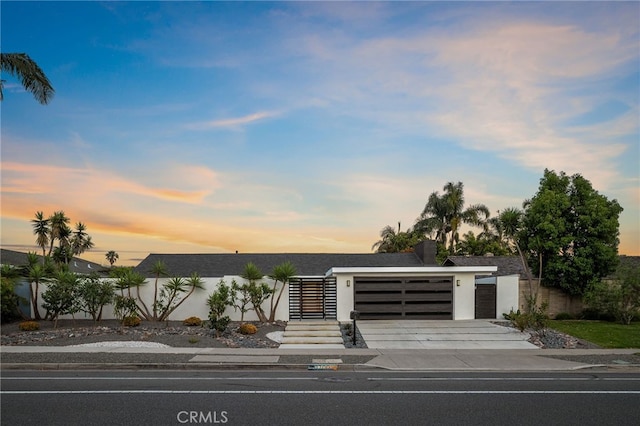 1700 Irvine Ave, Newport Beach, CA 92660 - contemporary home featuring a garage, driveway, and stucco siding